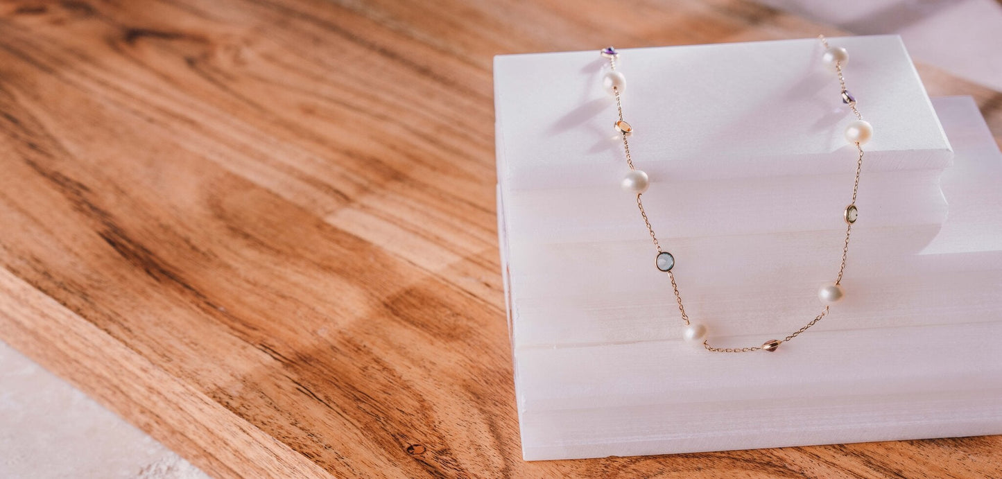 Oceana Glow Akoya pearl pendant necklace flat-lay on white stand